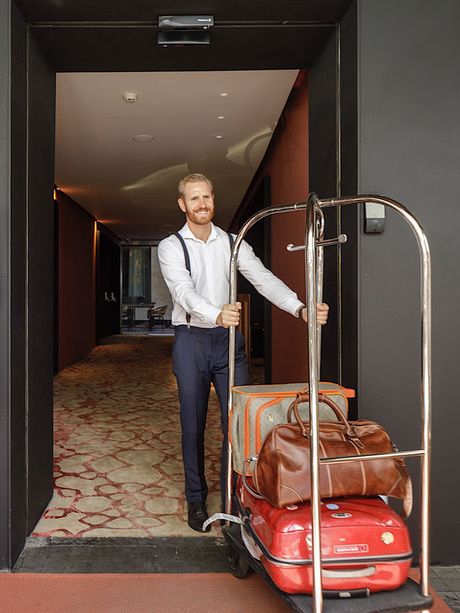 Staff with luggage at EME Catedral Mercer Hotel