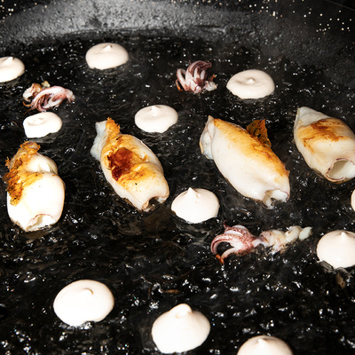 Black rice paella with squid and alioli at Restaurant Al Lado in the Hotel EME Catedral Mercer