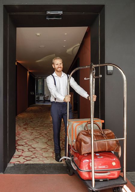Staff with luggage at the EME Catedral Mercer Hotel